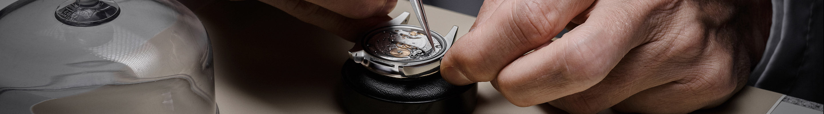 A watchmaker holding the watch and checking rolex watch